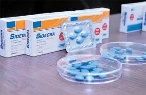 Comparison of Pfizer Viagra and Thai GPO Sidegra boxes on a table